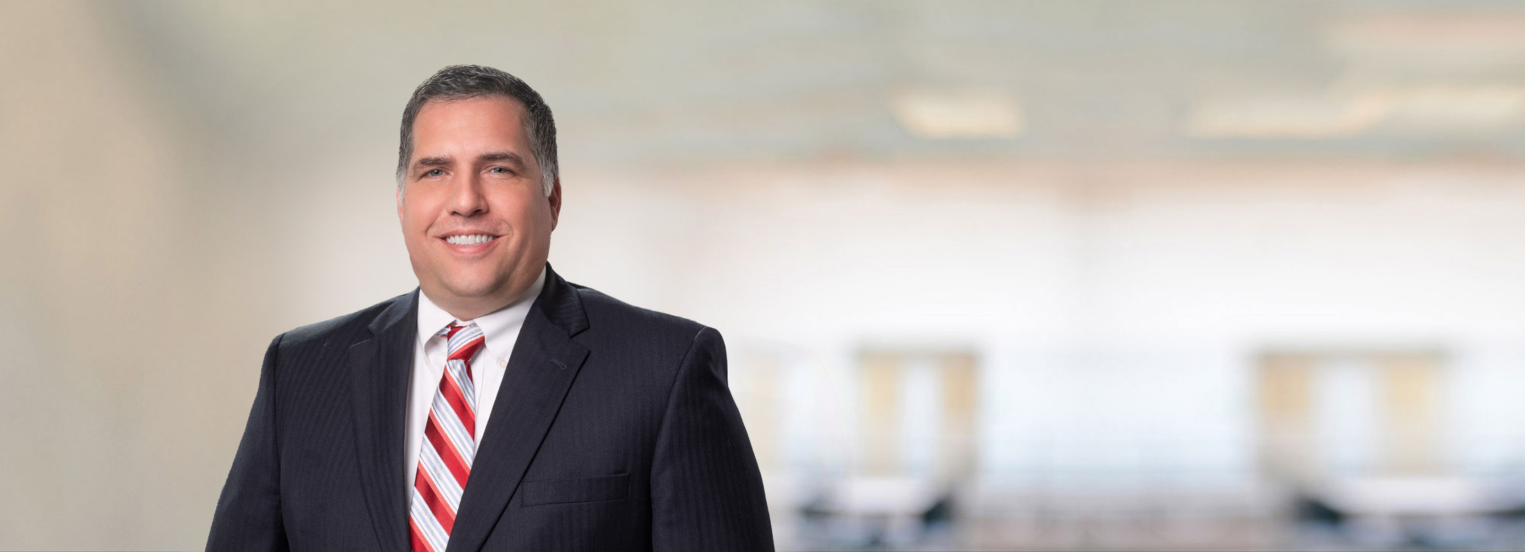 Professional Photo of man with Black Suit and red striped tie